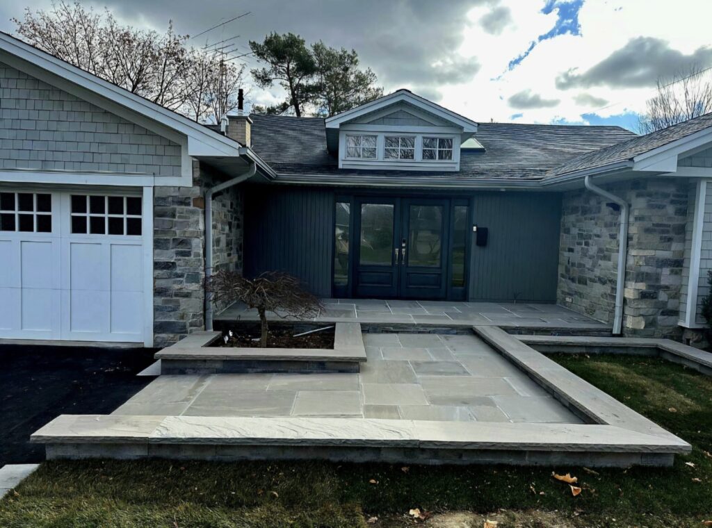 Heated Two-Level Front Landing with Slate Grey Flagstone, Oaks Modan Wall Flower Beds & Slate Grey Rock-Faced Coping | Serving Aurora, Newmarket, Stouffville, Richmond Hill, Nobleton, King City, North York, Vaughan, Etobicoke and Oakville