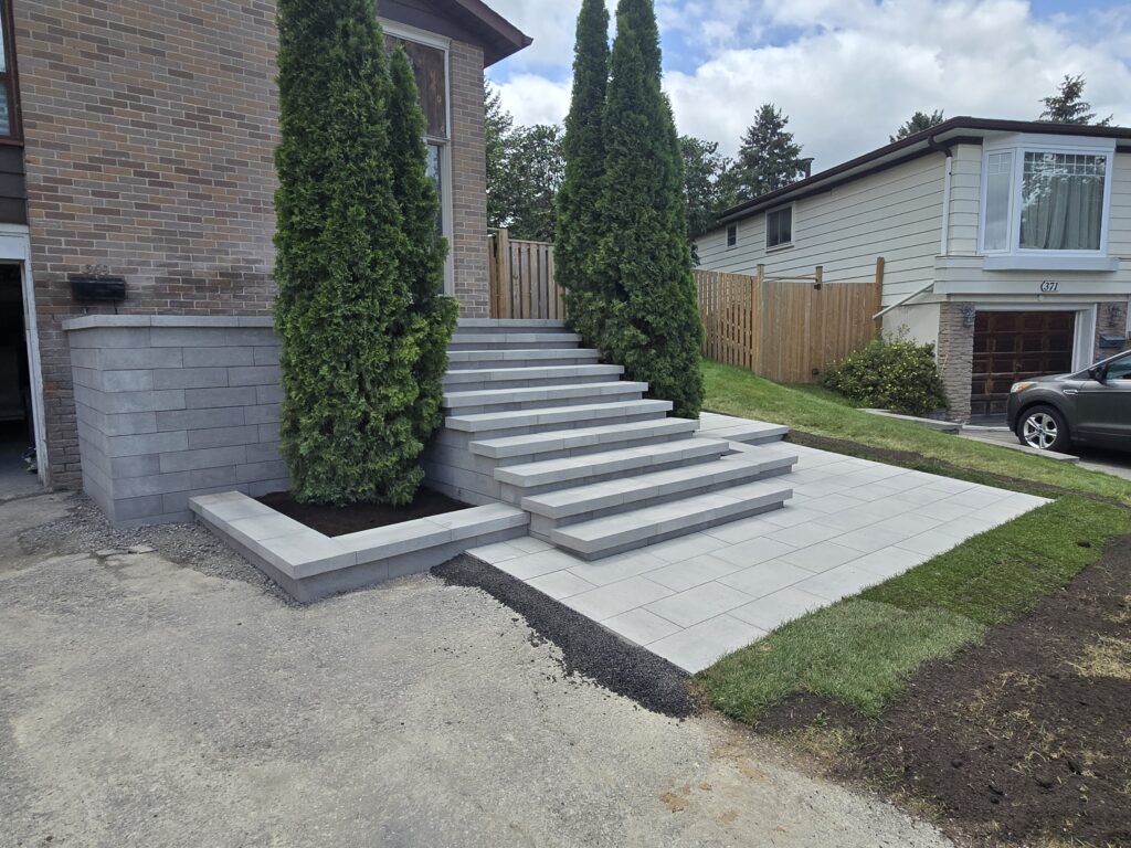 Newmarket front entrance with Oaks Nueva 150 step blocks, Oaks interlocking pavers, and a matching front walkway installed by Premier Masonry Inc.