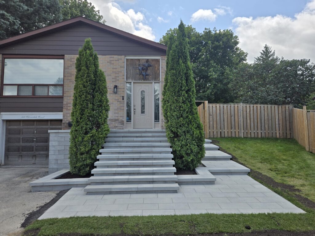 Newmarket front entrance with Oaks Nueva 150 step blocks, Oaks interlocking pavers, and a matching front walkway installed by Premier Masonry Inc.
