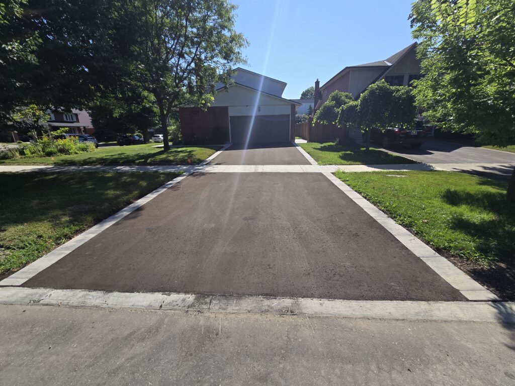Newmarket asphalt driveway with Oaks 60mm Marble Grey interlocking paver borders and matching front walkway installed by Premier Masonry Inc.