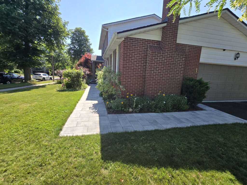 Newmarket sidewalk extension featuring Oaks 60mm Marble Grey interlocking pavers connecting the driveway to the side entrance and natural stone front porch.