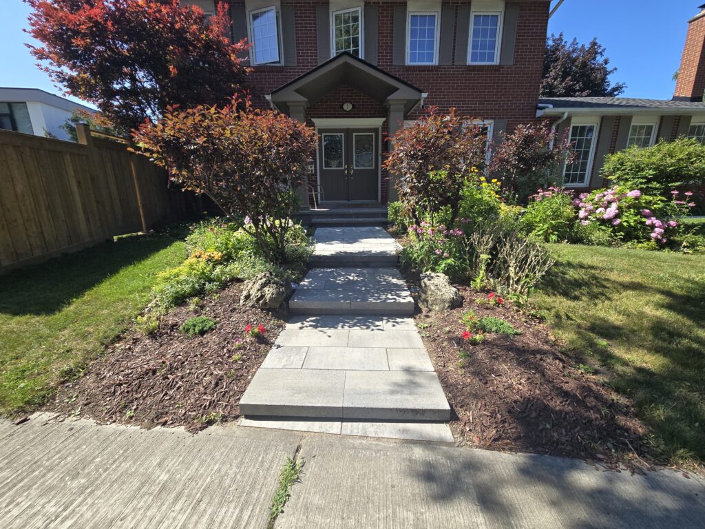 Newmarket front steps built with Oaks Nueva 150 Marble Grey step blocks and matching Oaks Marble Grey interlocking paver landings by Premier Masonry Inc