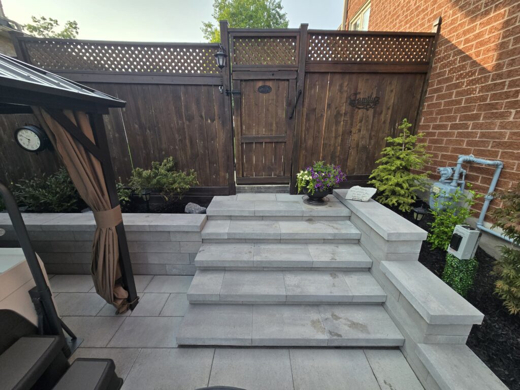 Newmarket backyard steps with Oaks Nueva 150 Cloudburst retaining walls and garden beds