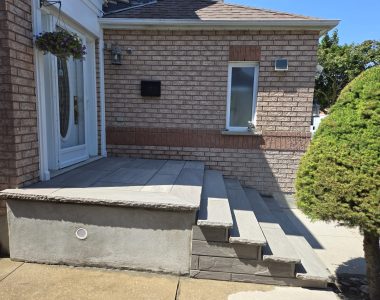 Four custom poured 8 ft steps with 14-inch slate grey rock-faced coping and flagstone porch